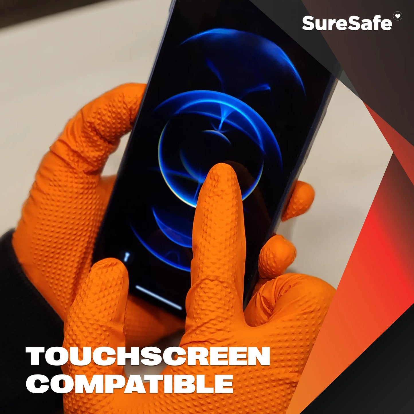 Person wearing 8 mil SureSafe IGRIP orange gloves using a smartphone to show touchscreen sensitivity for site safety.