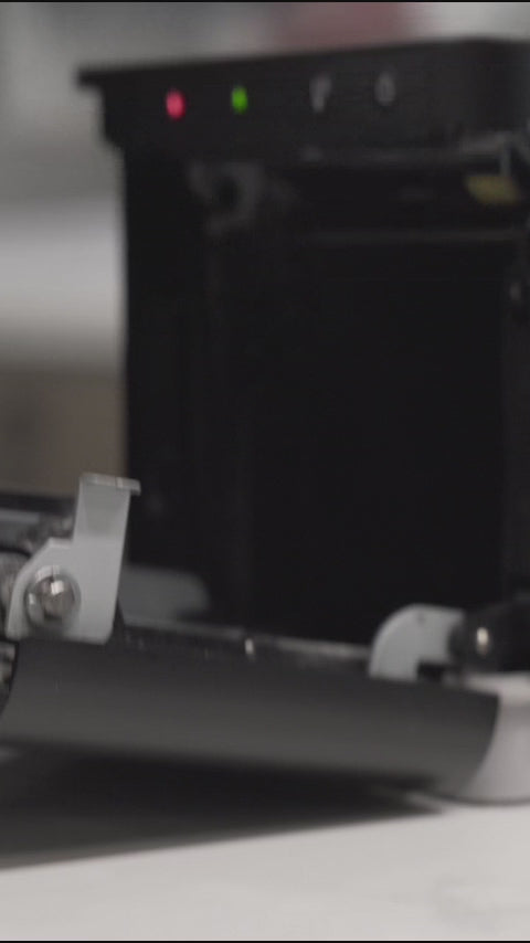 Quick loading of a SureSafe thermal paper roll into a professional POS receipt printer for retail efficiency.