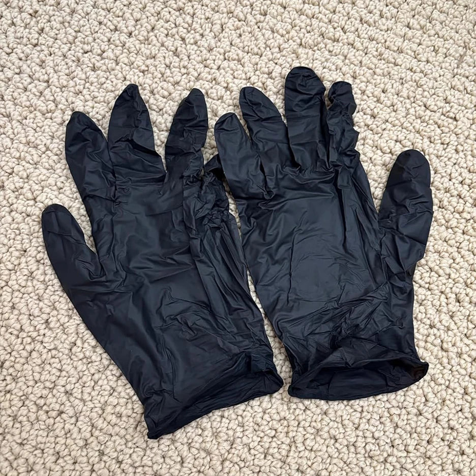 Review of SureSafe Professional Obsidian black nitrile gloves showing durable 5 mil thickness and a secure textured grip.
