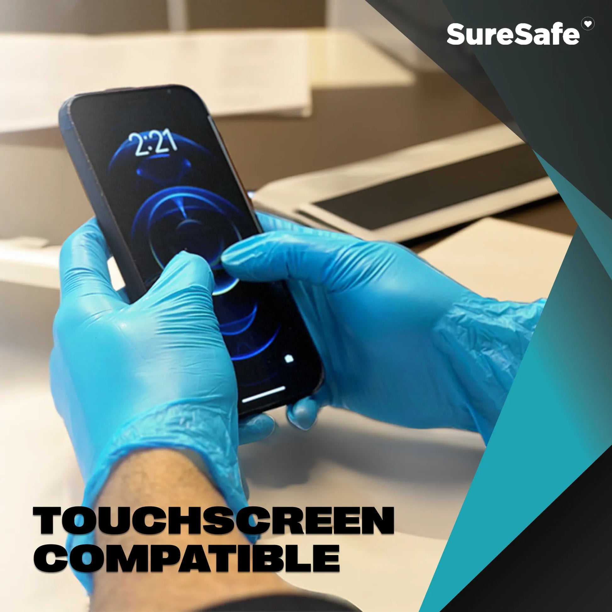 Person wearing blue SureSafe Hybrid Blend gloves using a smartphone to show touchscreen sensitivity for busy professionals.